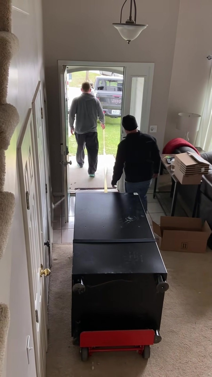 An Everyday Movers crew carefully carrying a piece on a Worcester job
